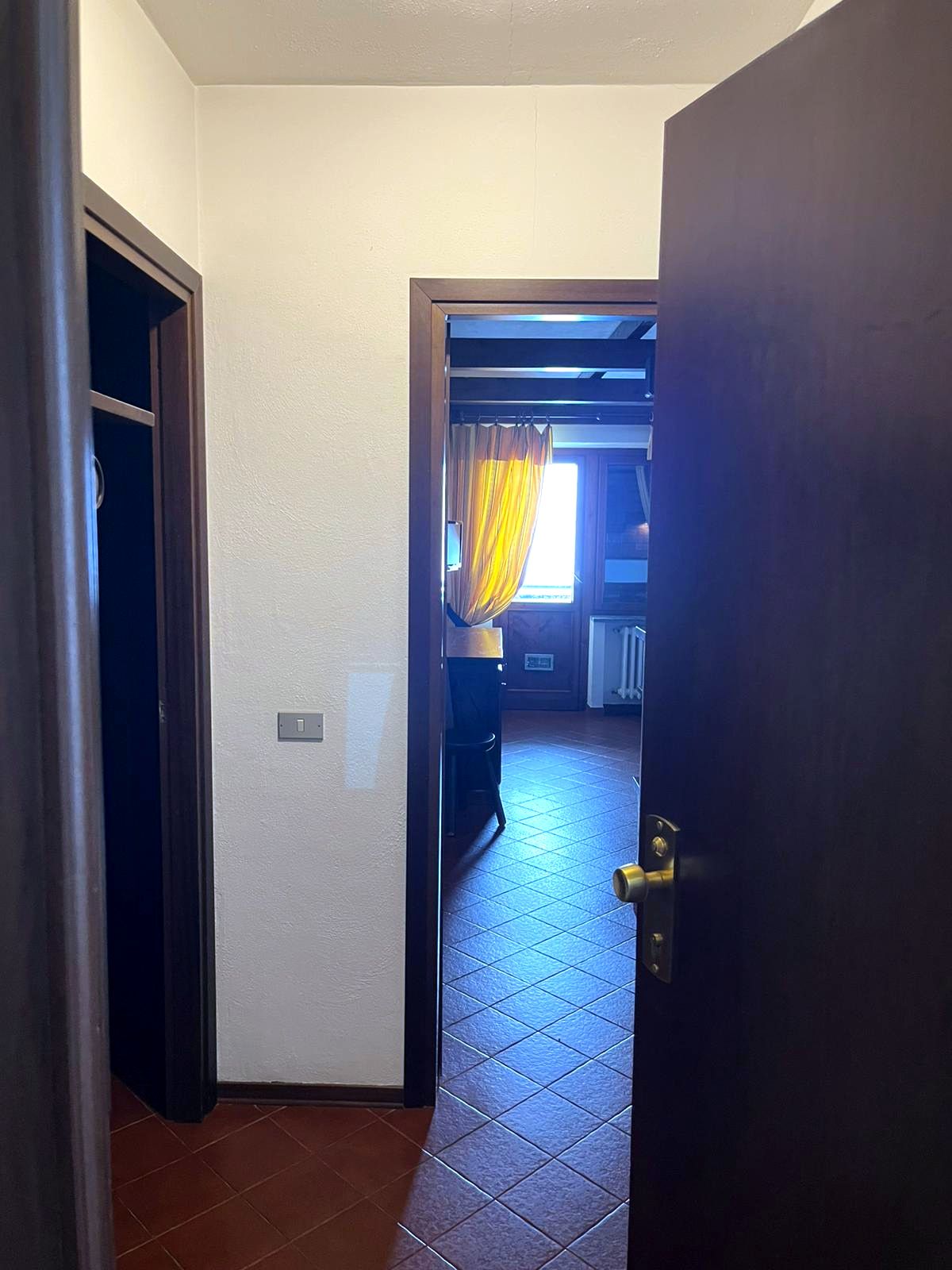Ingresso dell’appartamento con armadio a muro e vista verso il soggiorno